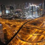 Stunning aerial view of Dubai's illuminated highways and skyscrapers at night.