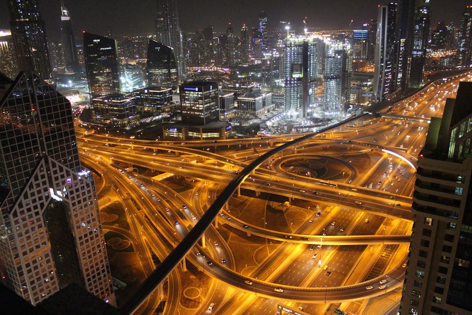 Stunning aerial view of Dubai's illuminated highways and skyscrapers at night.