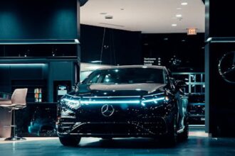 Luxurious black Mercedes-Benz displayed in a futuristic showroom setting.