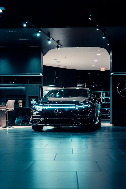 Luxurious black Mercedes-Benz displayed in a futuristic showroom setting.