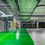 Modern green electric car charging station in an underground parking lot, eco-friendly urban solution.