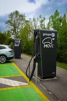 Electric vehicle charging station outdoors surrounded by nature, promoting sustainable travel.