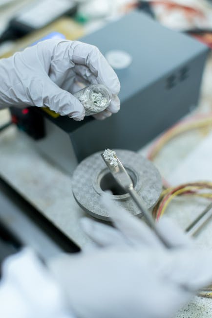 Technician inspecting and testing an opened electric vehicle battery pack before module replacement.